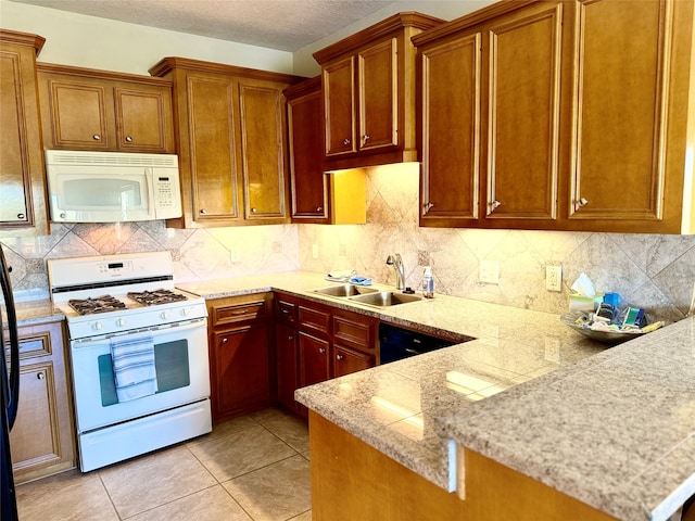 kitchen featuring white appliances, backsplash, sink, light tile patterned flooring, and kitchen peninsula