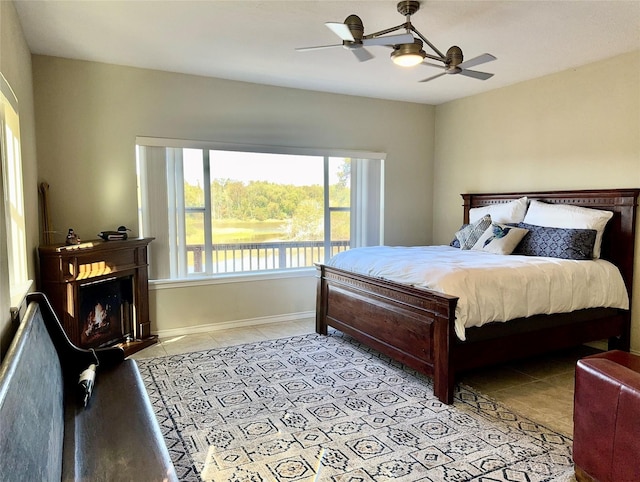 113 Cottonwood Rd, Trinity, TX 75862 - bedroom with light tile patterned floors, a fireplace, and ceiling fan