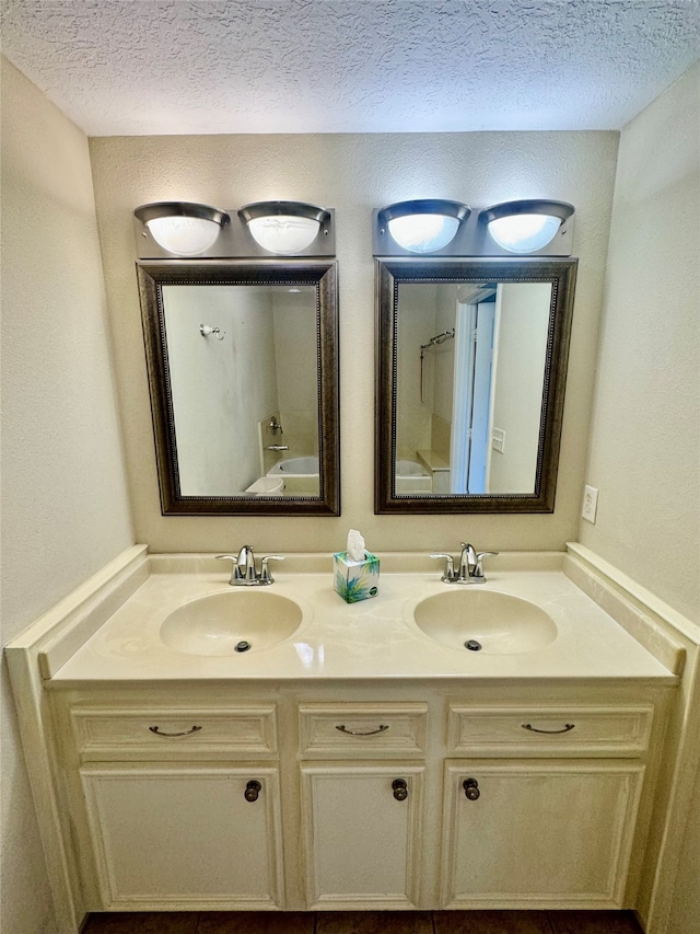 bathroom with vanity and a textured ceiling