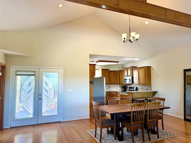 113 Cottonwood Rd, Trinity, TX 75862 - dining space with high vaulted ceiling, a chandelier, french doors, light wood-style flooring, and baseboards