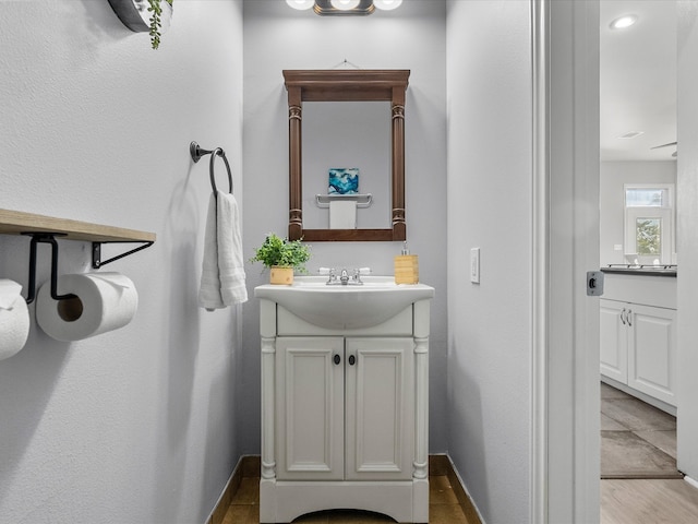 bathroom with vanity and hardwood / wood-style flooring