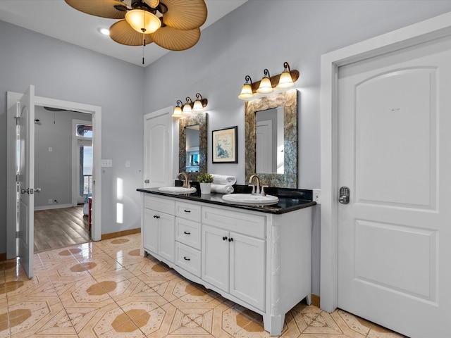 bathroom with hardwood / wood-style flooring, vanity, and ceiling fan