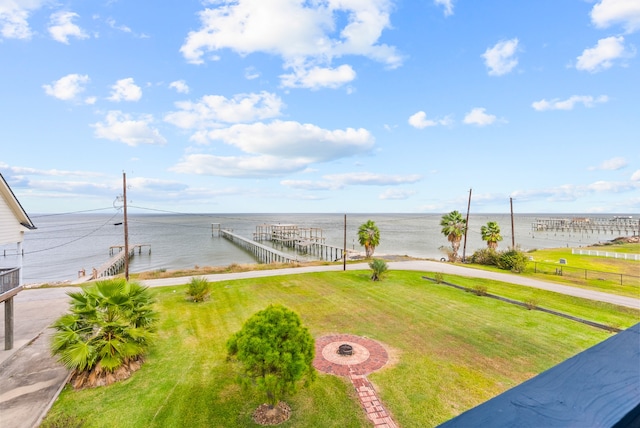 view of yard with a boat dock and a water view