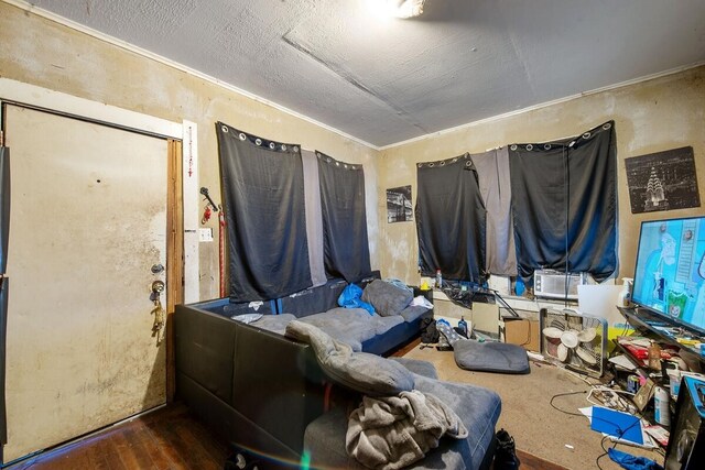 interior space with wood-type flooring and crown molding