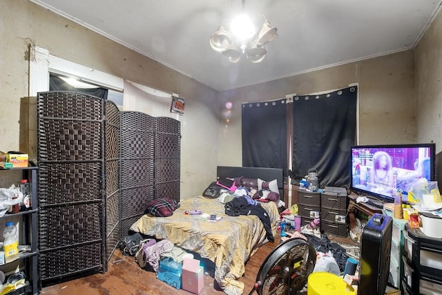 bedroom featuring ornamental molding, wood-type flooring, and a notable chandelier