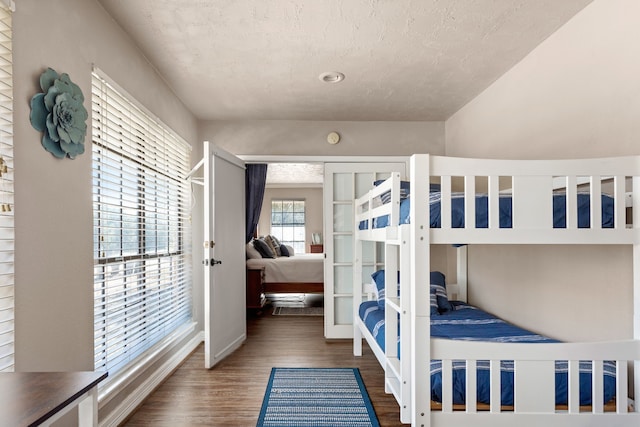 1464 Lakeside Dr W, Canyon Lake, TX 78133 - bedroom with dark hardwood / wood-style floors, a textured ceiling, and french doors