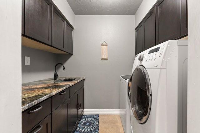 1464 Lakeside Dr W, Canyon Lake, TX 78133 - laundry room with cabinets, sink, separate washer and dryer, a textured ceiling, and light tile patterned flooring