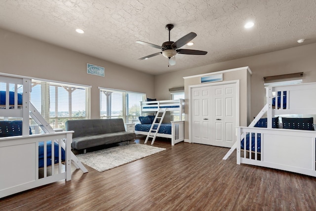 1464 Lakeside Dr W, Canyon Lake, TX 78133 - bedroom featuring dark hardwood / wood-style flooring, ceiling fan, a closet, and a textured ceiling