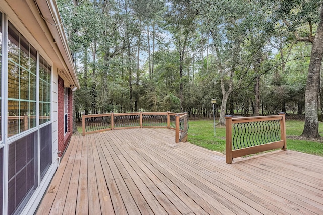 wooden deck featuring a lawn