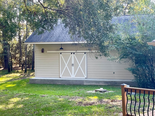 view of outbuilding with a lawn