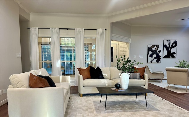 living room with light wood-type flooring and ornamental molding