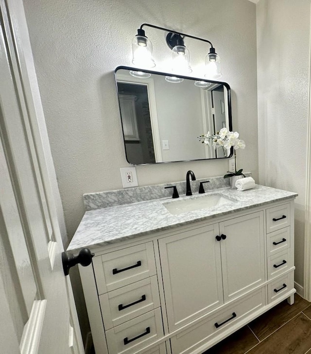 bathroom with hardwood / wood-style floors and vanity