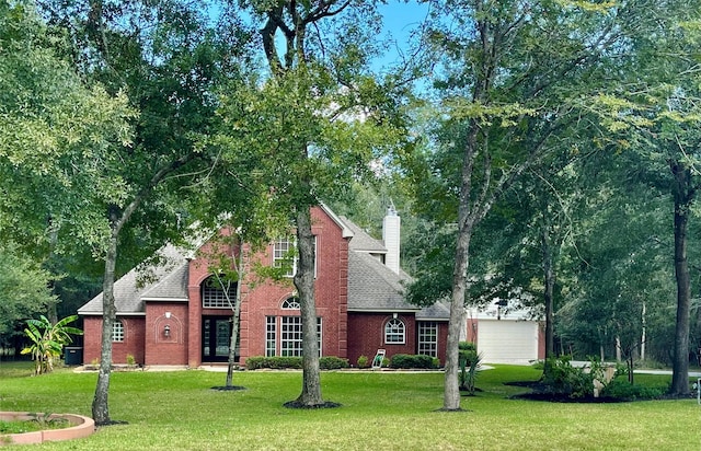 view of front of house featuring a garage and a front lawn