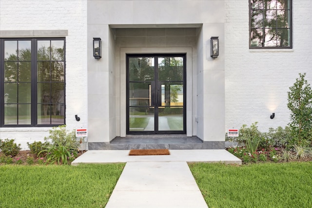 doorway to property with a yard