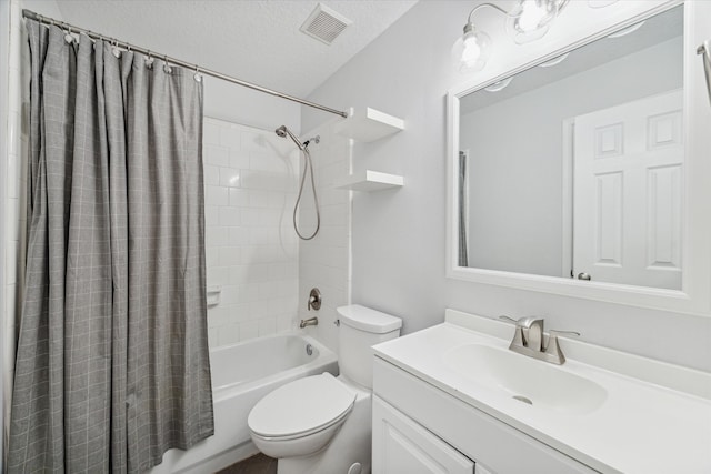 full bathroom featuring shower / bath combination with curtain, toilet, a textured ceiling, and vanity