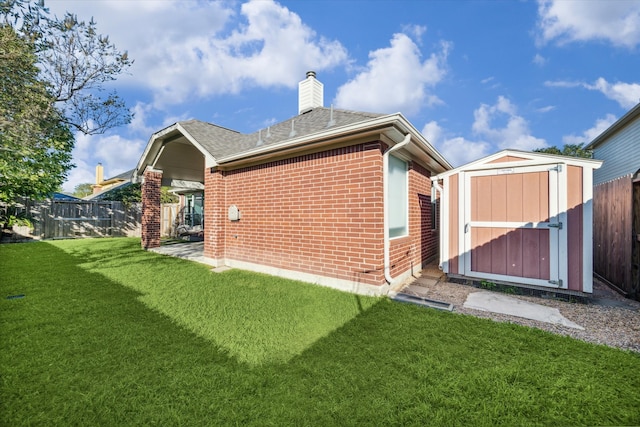 back of property featuring a storage unit and a yard