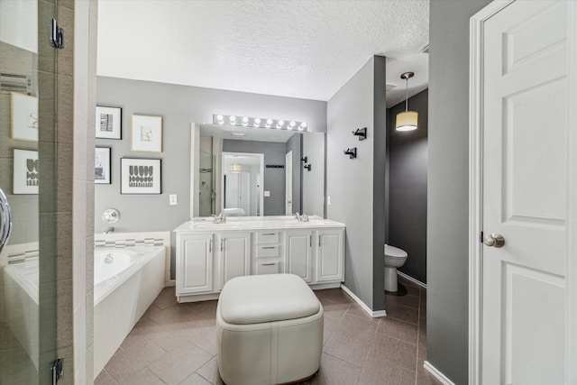 full bathroom featuring tile patterned floors, vanity, independent shower and bath, and a textured ceiling