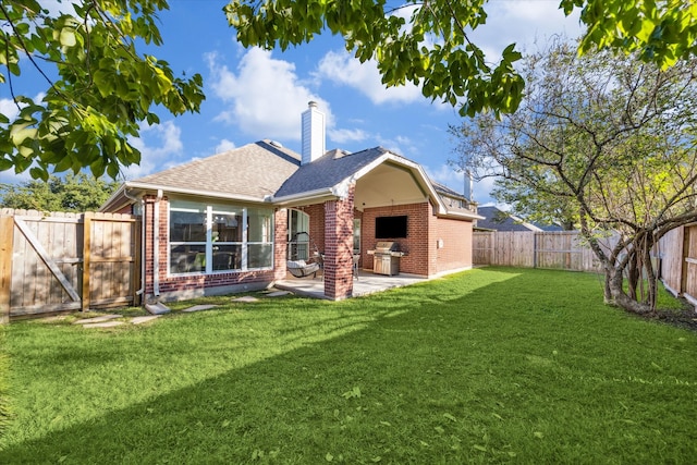 back of property featuring a lawn and a patio