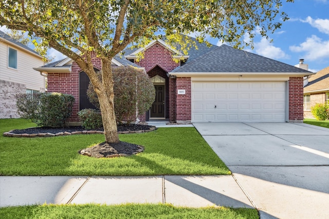 view of front of home featuring a front yard and a garage