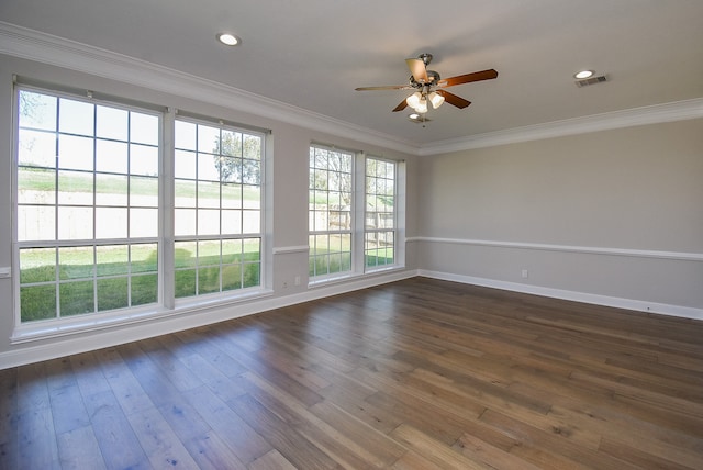 empty room with ceiling fan, dark hardwood / wood-style flooring, and ornamental molding