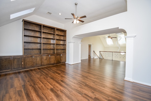 unfurnished living room featuring lofted ceiling, decorative columns, ceiling fan, and dark wood-type flooring