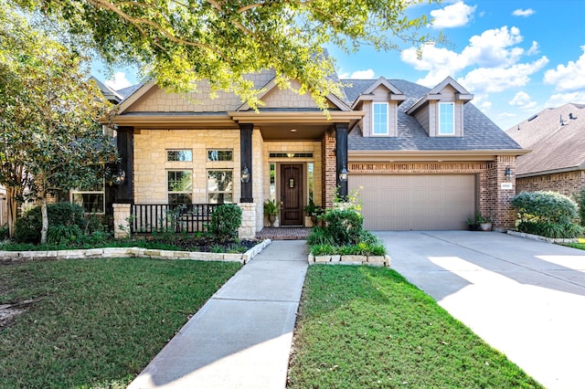 craftsman-style home featuring a front lawn, a porch, and a garage