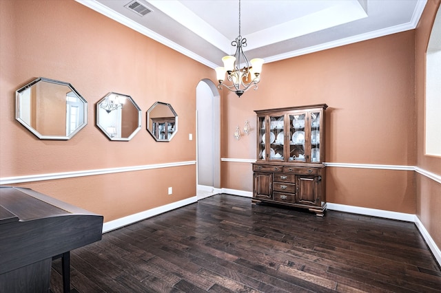 interior space featuring dark hardwood / wood-style flooring, crown molding, and a tray ceiling