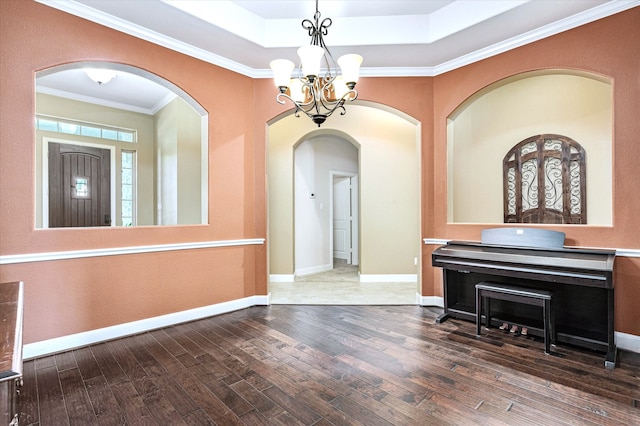 interior space featuring an inviting chandelier, ornamental molding, and hardwood / wood-style flooring