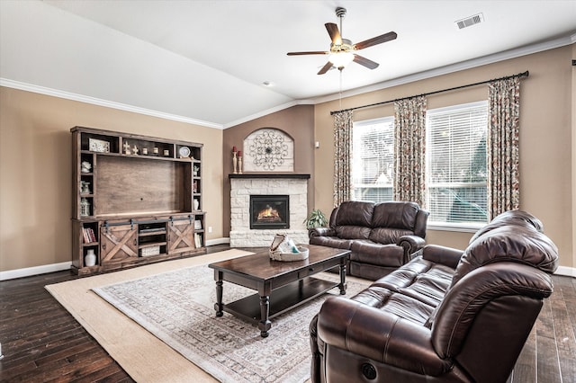 living room featuring lofted ceiling, dark hardwood / wood-style floors, ceiling fan, ornamental molding, and a fireplace