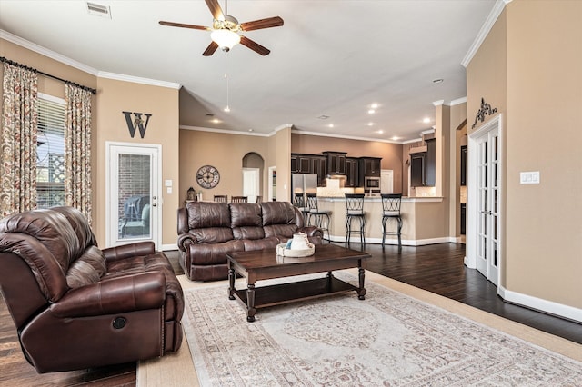 living room featuring french doors, dark hardwood / wood-style floors, ceiling fan, and ornamental molding