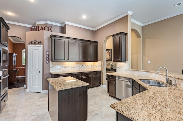 kitchen featuring sink, light stone counters, crown molding, and stainless steel appliances