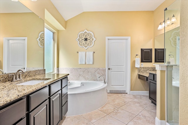 bathroom with a bathing tub, tile patterned flooring, vanity, and lofted ceiling