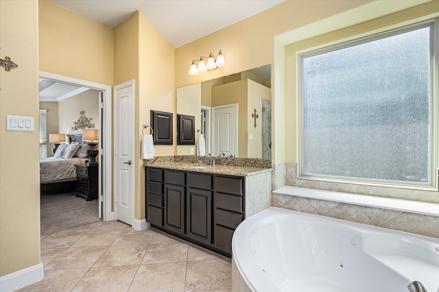 bathroom with tile patterned floors, crown molding, vanity, and a bath