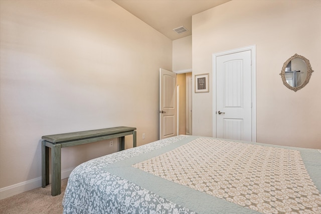 carpeted bedroom featuring high vaulted ceiling