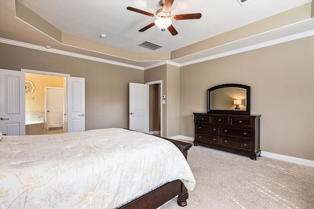 bedroom with ensuite bathroom, light colored carpet, a raised ceiling, ceiling fan, and crown molding