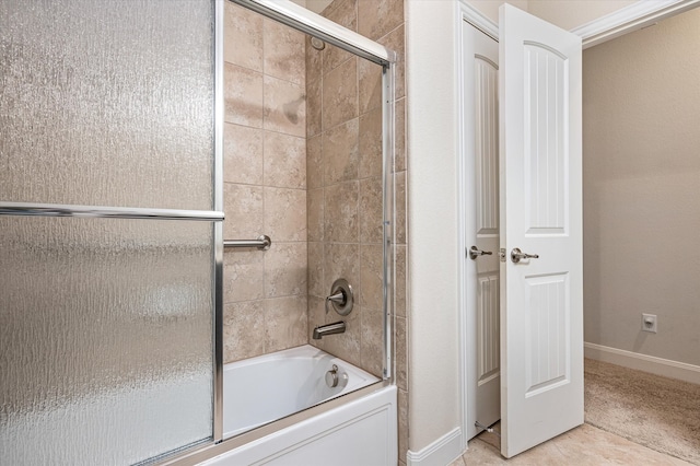 bathroom featuring shower / bath combination with glass door and tile patterned floors