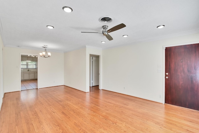 unfurnished room with ceiling fan with notable chandelier, light hardwood / wood-style floors, and ornamental molding