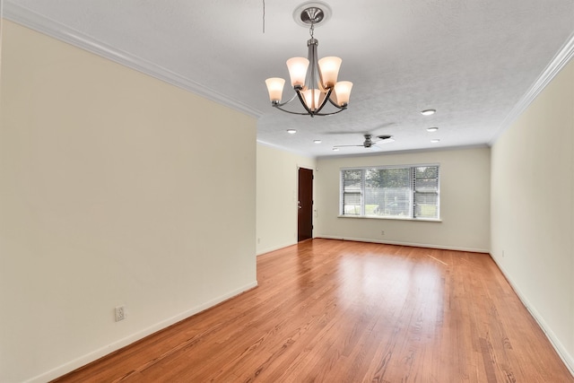 unfurnished room featuring a textured ceiling, ceiling fan with notable chandelier, light wood-type flooring, and ornamental molding