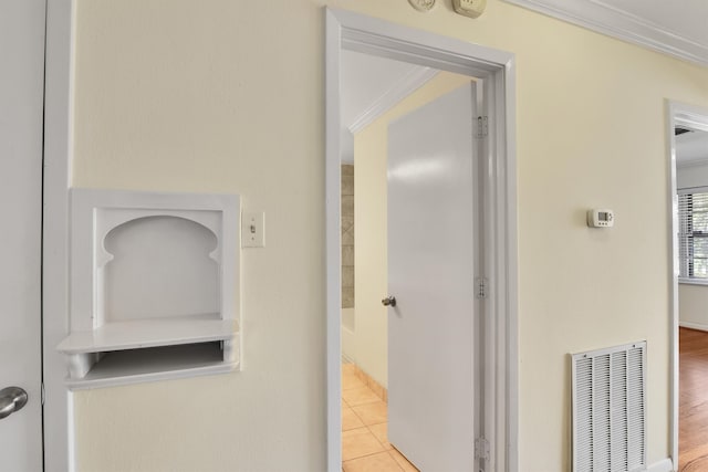 corridor with crown molding and light hardwood / wood-style flooring