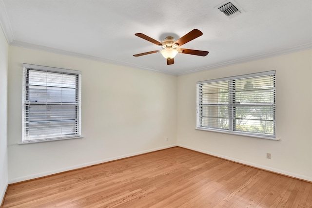 spare room featuring crown molding, ceiling fan, and light wood-type flooring