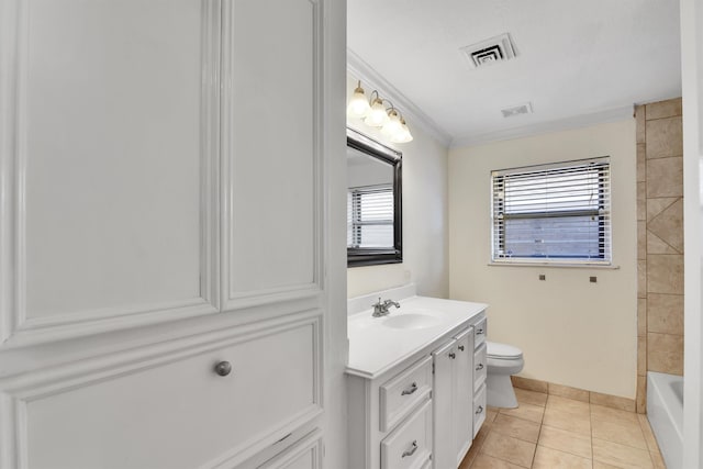 bathroom with toilet, vanity, tile patterned floors, and crown molding