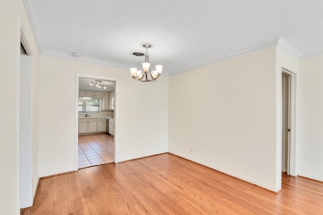 unfurnished dining area featuring a notable chandelier, light hardwood / wood-style floors, sink, and crown molding