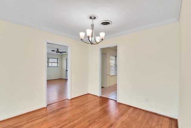 spare room featuring light hardwood / wood-style floors, ceiling fan with notable chandelier, and ornamental molding