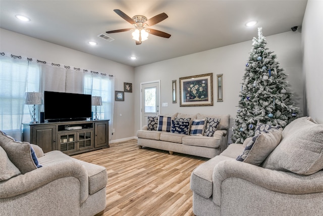 living room featuring ceiling fan and light wood-type flooring