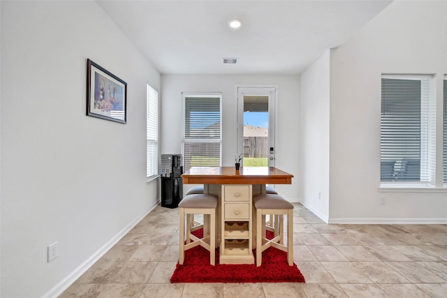 dining area with light tile patterned floors