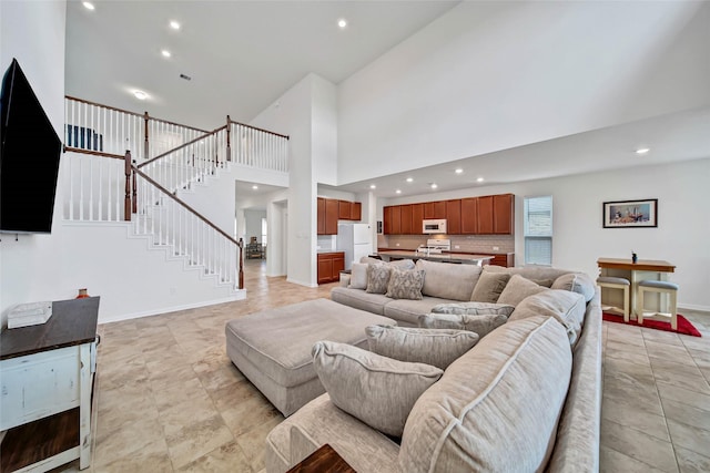 living room featuring a towering ceiling