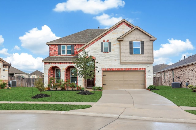 craftsman-style home featuring central air condition unit, a front yard, and a garage