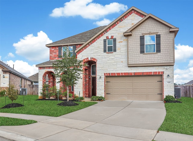 view of front of house featuring a garage, a front lawn, and central air condition unit