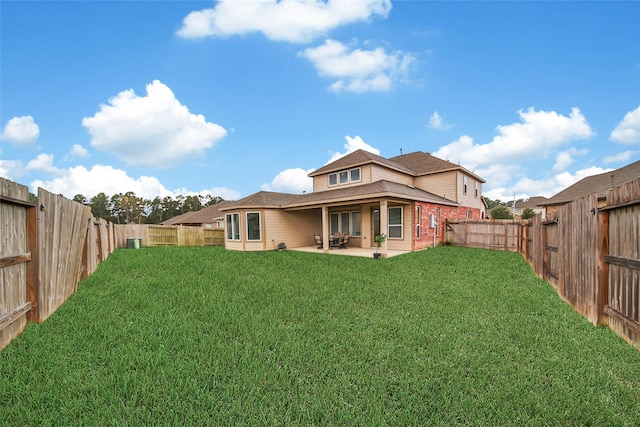 back of property featuring a yard and a patio area