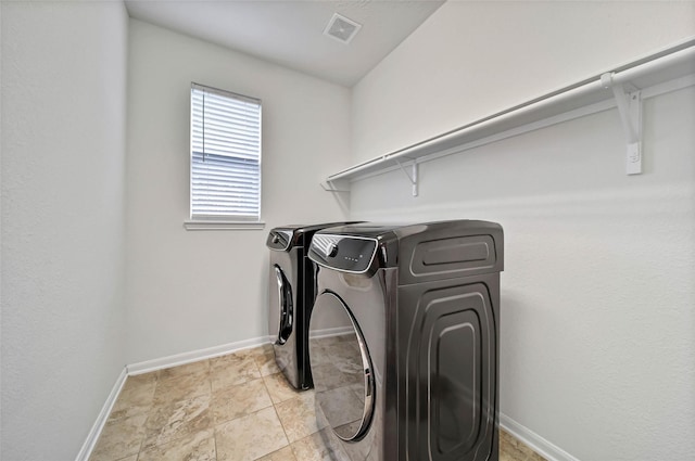 laundry area featuring washing machine and clothes dryer